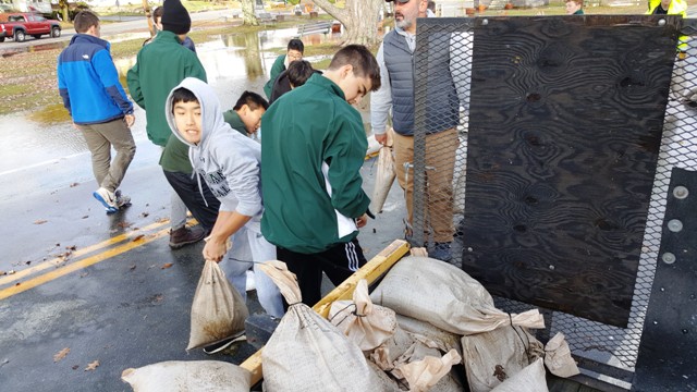 students helping with sandbags