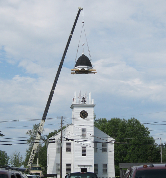 bell tower roof being lowered by crane