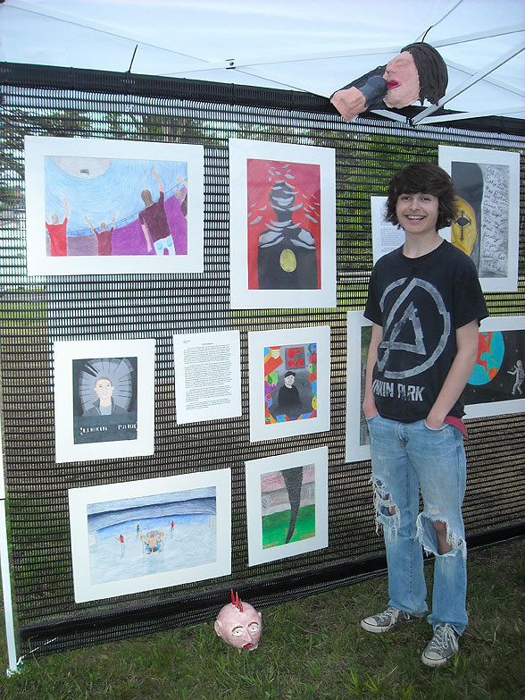 student displaying art