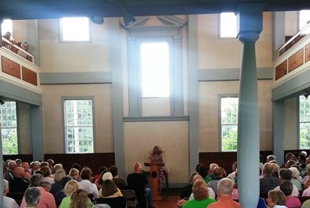 people listening to a meeting house readings author