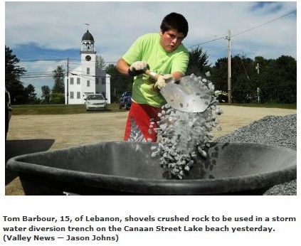 volunteer shoveling rock