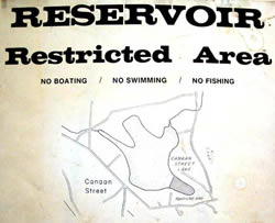 Sign at the water resevoir: shows image of lake and mentions swimming and boating restrictions