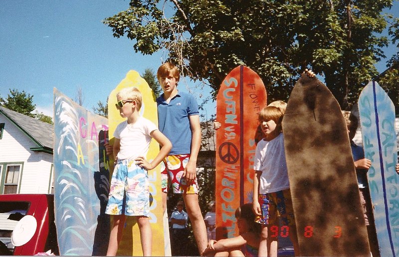 boys posing as surfers on parade float