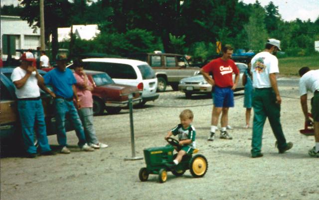 boy competing in toy tractor pull