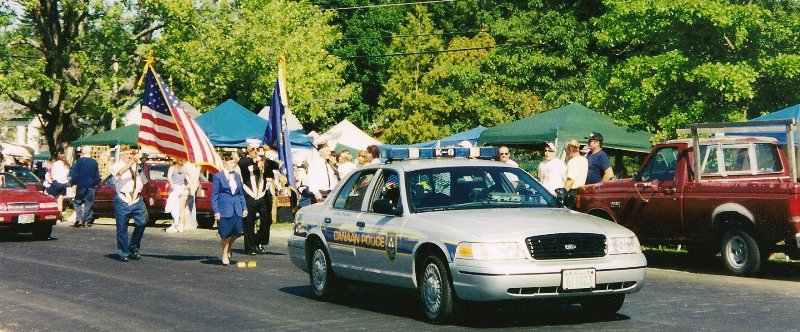 police car and color guard leading parade