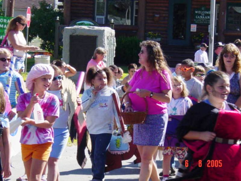 children dressed in bright clothes marching in parade