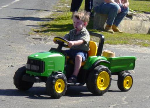 boy on toy tractor
