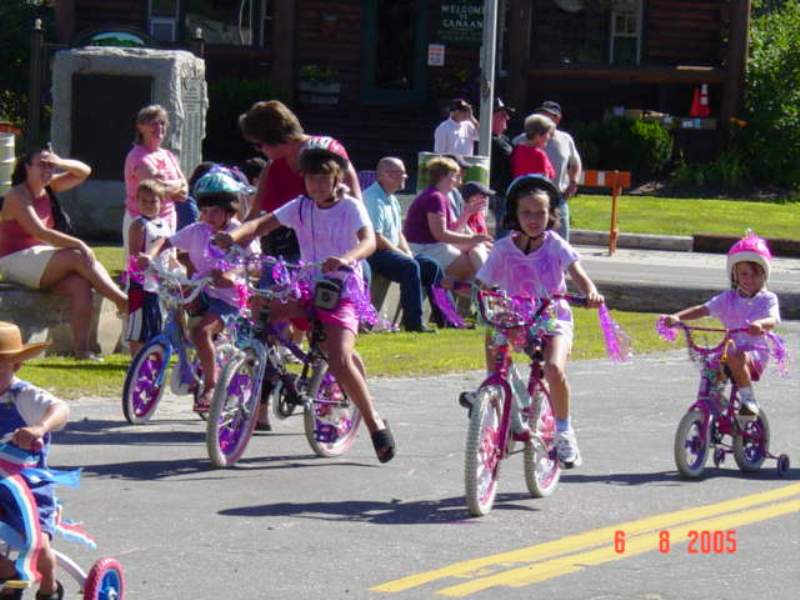 several girls dressed in pink riding pink bikes