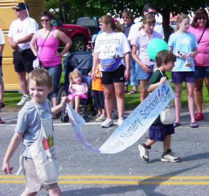 children from Indian River Nursery school carrying a banner