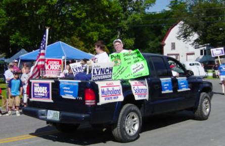 truck covered in political signs carrying candidates