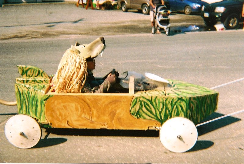 soap box derby car and driver dressed as a lion