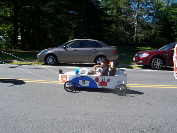 soap box derby car being pulled in parade