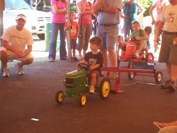 boy waiting on toy tractor