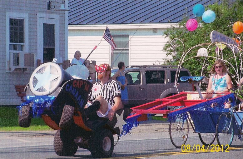 stunt lawn mower pulling a girl on a float