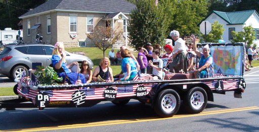 people waving from a parade float