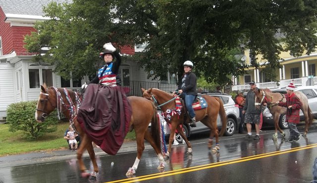 horses and riders dressed in red, white and blue